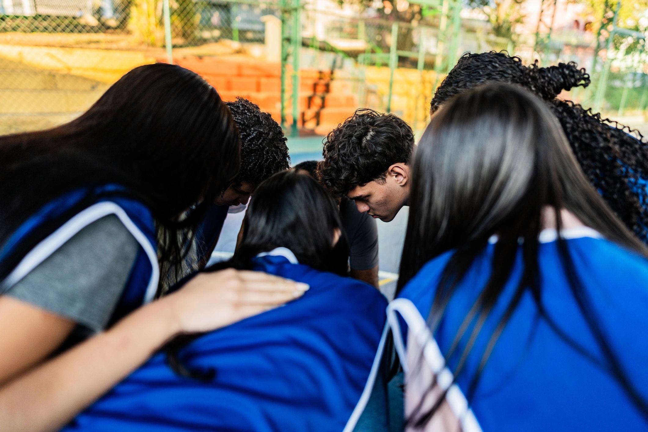 Students gathered with a coach on a school court